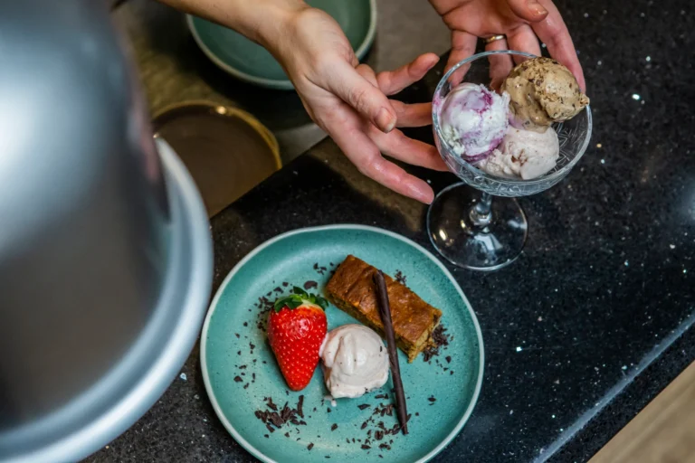Dessert plate with ice cream and strawberry.